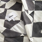Collar and button on a Black and White chess pattern long sleeved shirt