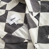 Collar and button on a Black and White chess pattern long sleeved shirt