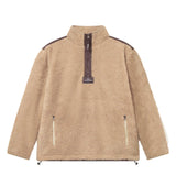A beige-colored half zip fleece pullover with two front zipper pockets and a ' Nikben ' patch on the chest.