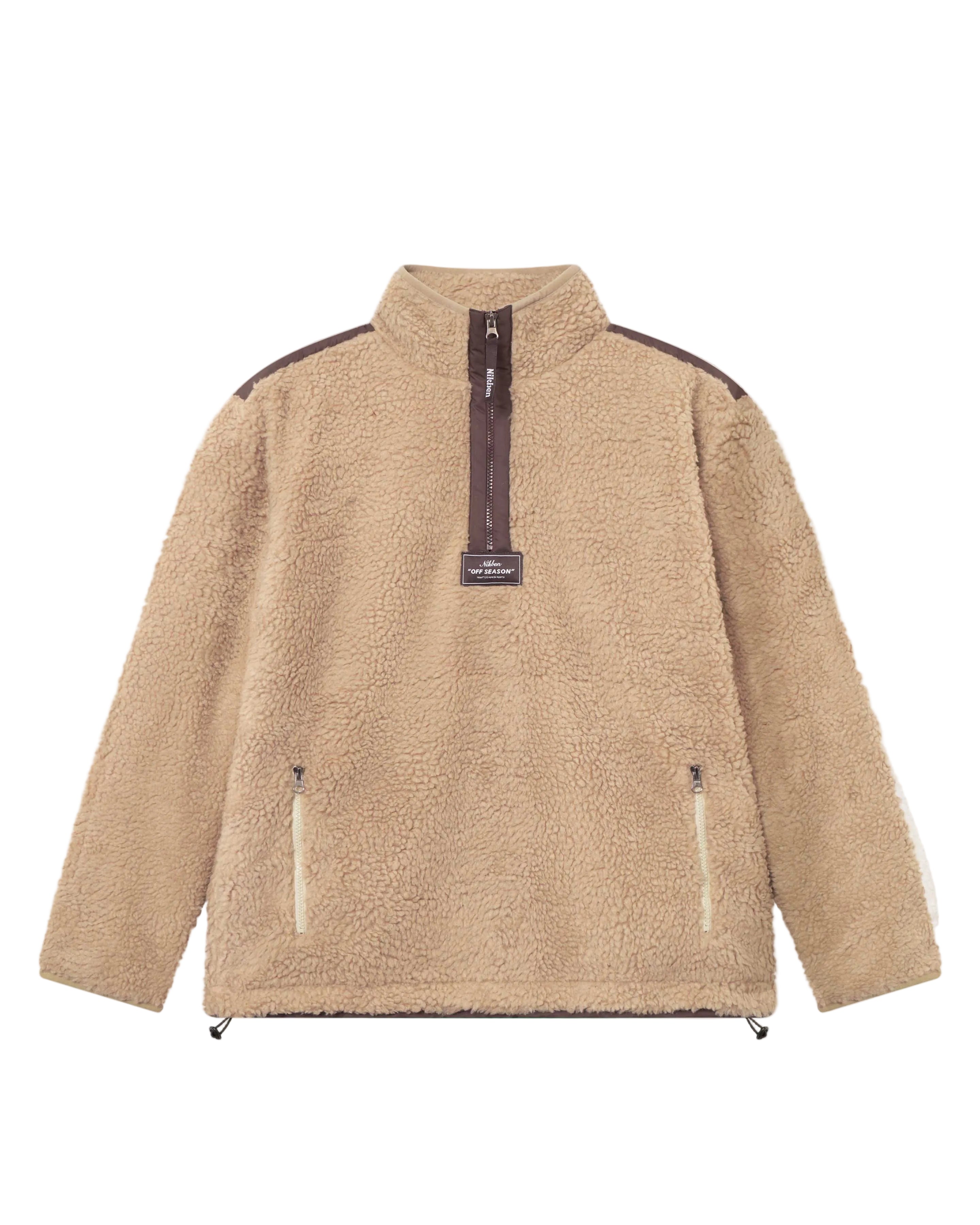 A beige-colored half zip fleece pullover with two front zipper pockets and a ' Nikben ' patch on the chest.