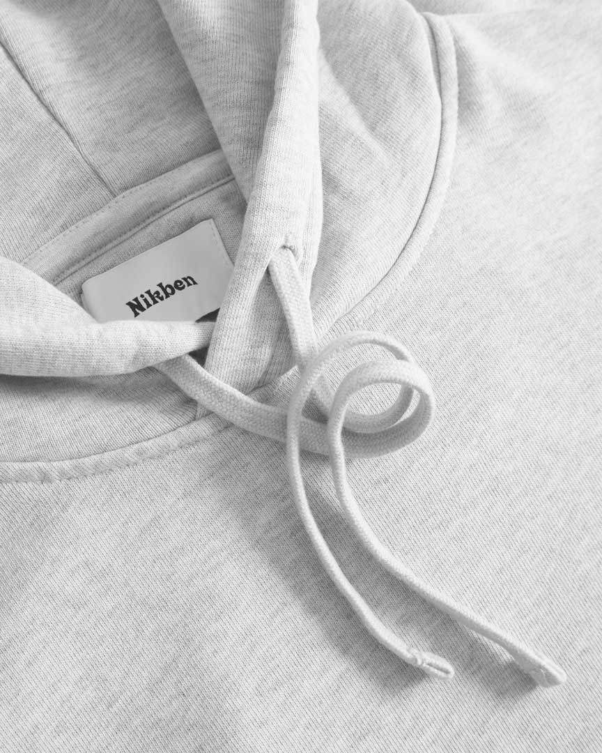Close up of drawstrings on a grey hoodie