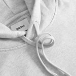 Close up of drawstrings on a grey hoodie