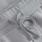 Close up of drawstrings on grey sweat shorts