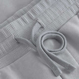 Close up of drawstrings on grey sweat shorts