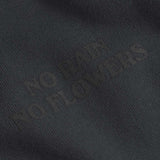 Close up of "no rain no flowers" print on a black cropped hoodie