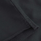 Close up of black cropped hoodie with drawstrings and ribbed cuffs