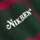 Close up of embroidery on a Green and pink colored lumberjack jacket with pockets
