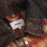 Close up of collar on an orange red colored lumberjack jacket with pockets, full zipper and embroidered Nikben logo 
