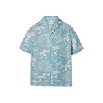 A light blue short-sleeved men's shirt with a multicolor graphic pattern, an open collar, and a button closure at the front.