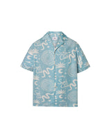 A light blue short-sleeved men's shirt with a multicolor graphic pattern, an open collar, and a button closure at the front.