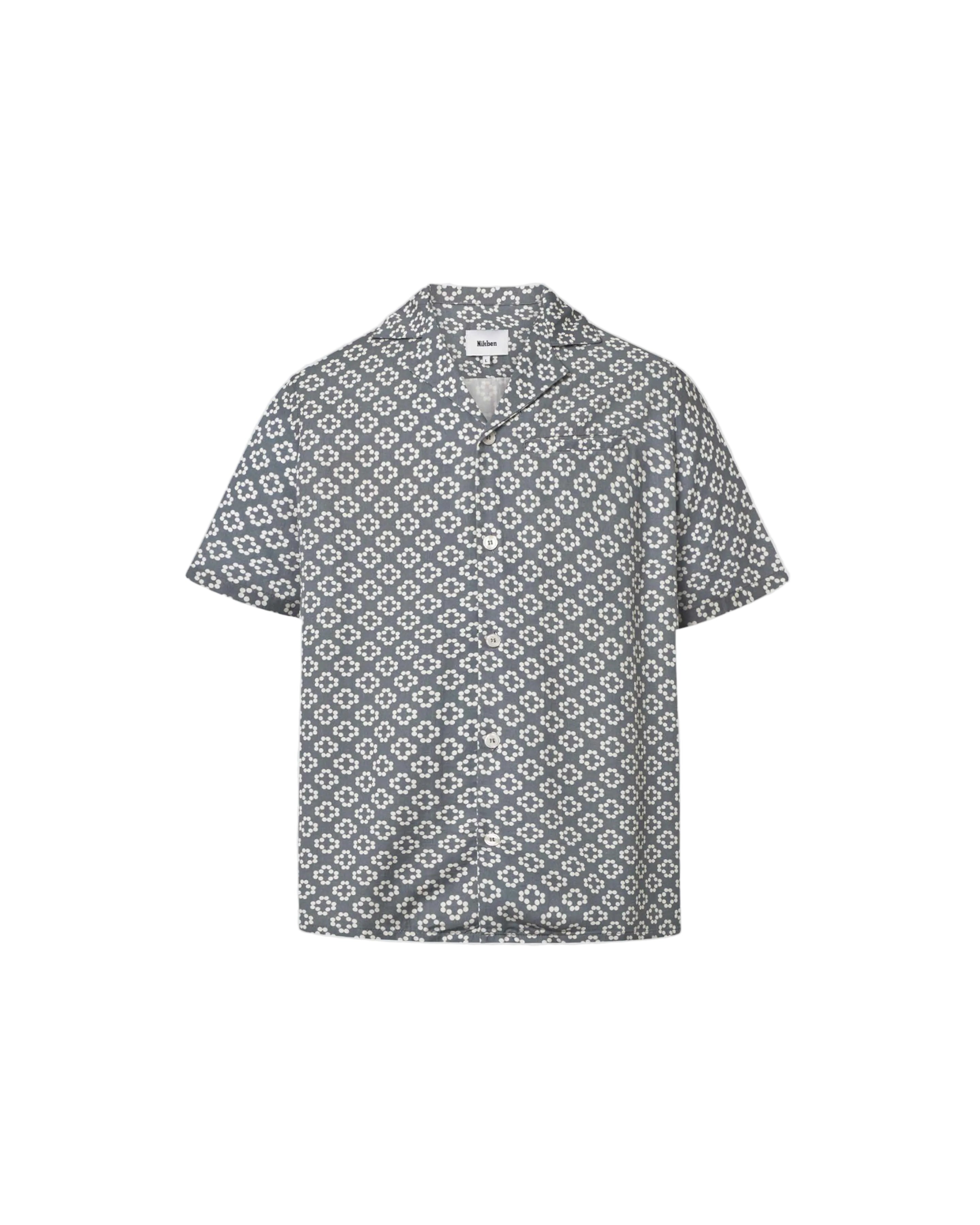 A short-sleeved steel blue shirt with a multicolor geometric pattern, an open collar, and button closure at the front.