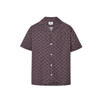 A short-sleeved brown shirt with a multicolor geometric pattern, an open collar, and button closures at the front.