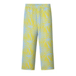 A pair of mustard yellow pants with a multicolor graphic pattern, featuring a relaxed fit and two side pockets.