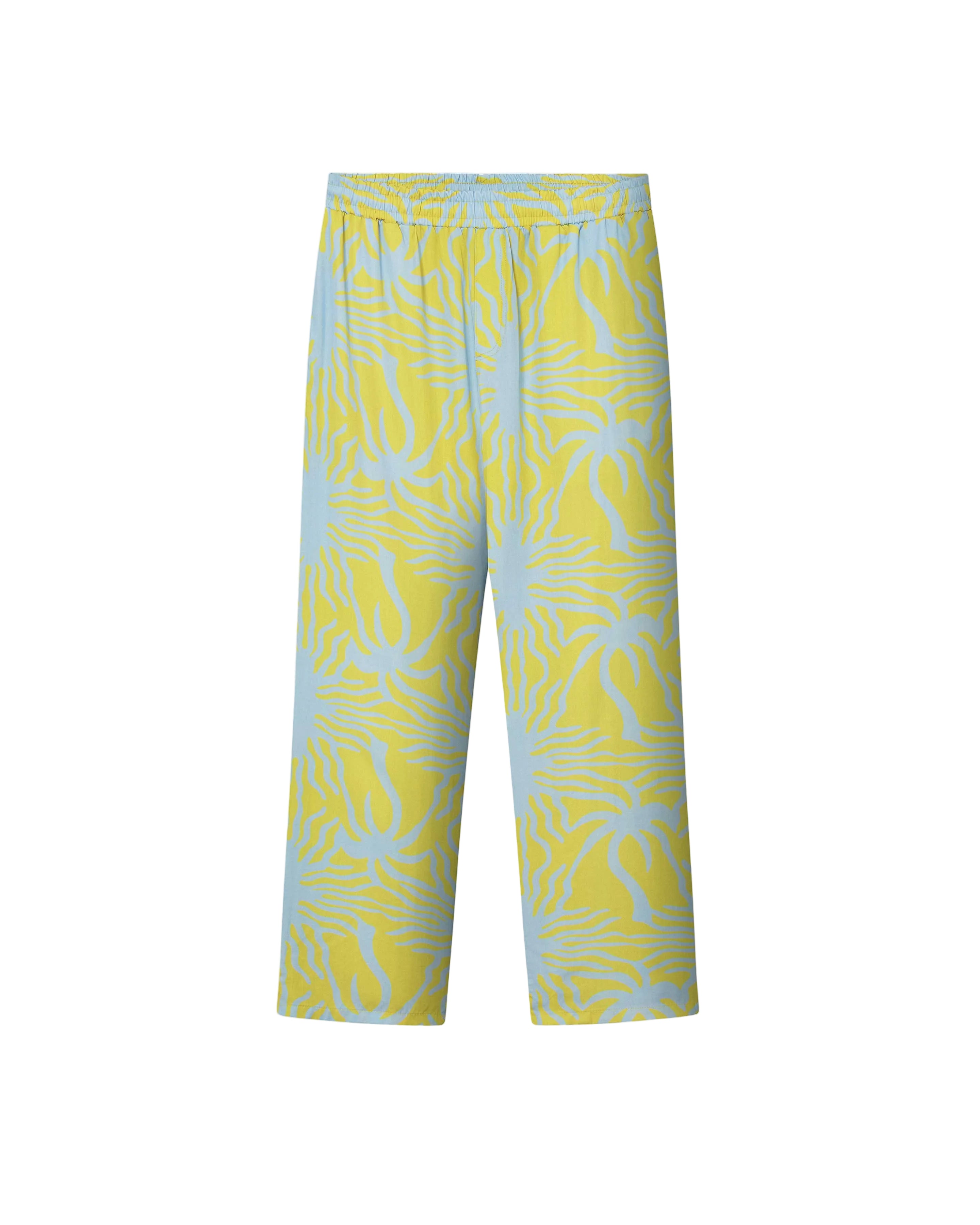 A pair of mustard yellow pants with a multicolor graphic pattern, featuring a relaxed fit and two side pockets.