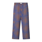 A pair of purple pants with a multicolor graphic pattern, featuring a relaxed fit and side pockets.