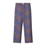 A pair of purple pants with a multicolor graphic pattern, featuring a relaxed fit and side pockets.