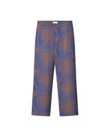 A pair of purple pants with a multicolor graphic pattern, featuring a relaxed fit and side pockets.