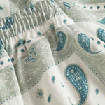 Close up of vintage pale yellow paisley pattern long pants