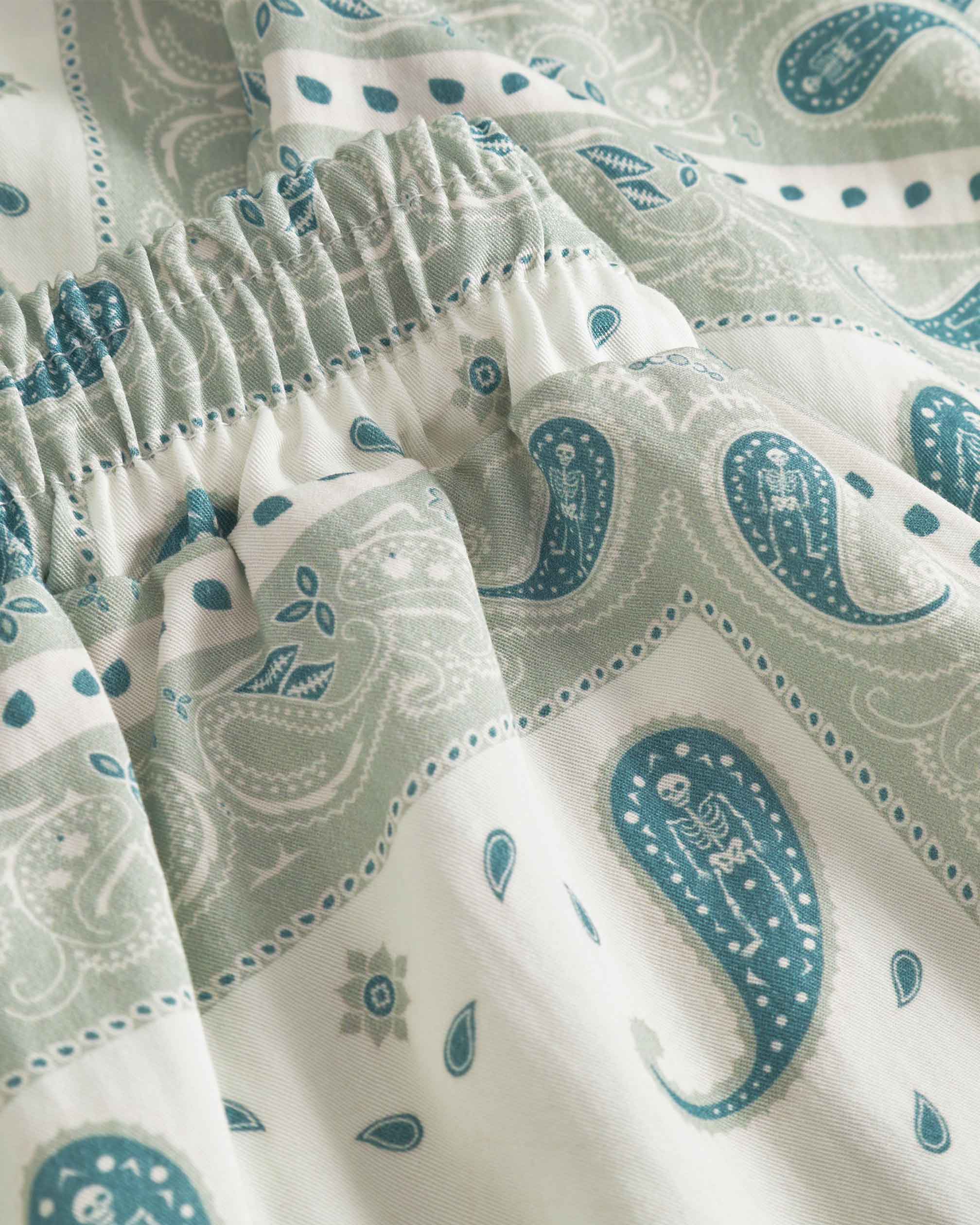 Close up of vintage pale yellow paisley pattern long pants