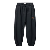 Black jogger pants with a small logo on leg