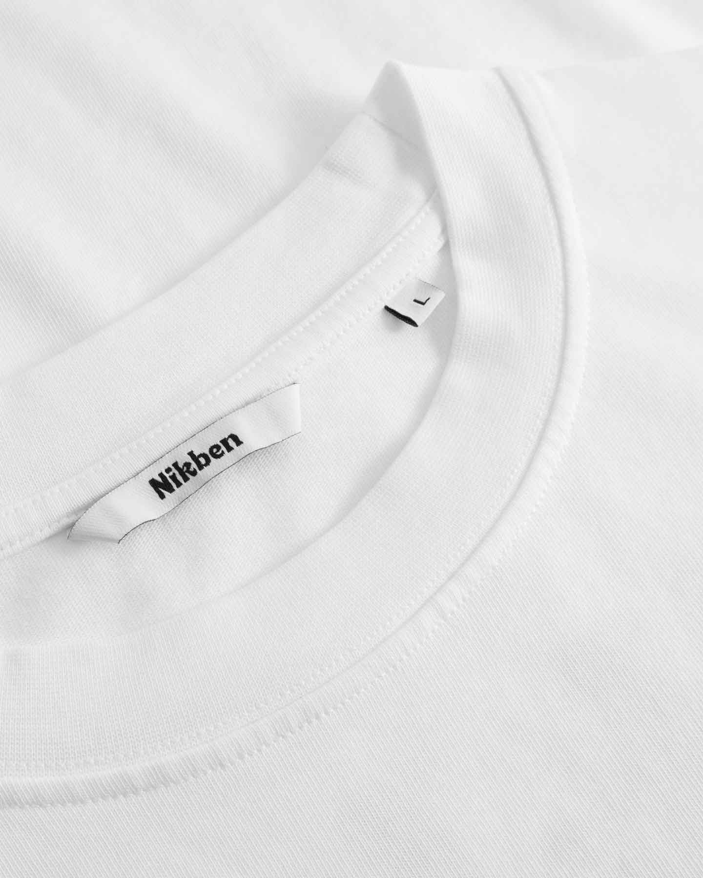 Close-up of a white t shirt with a brand label on a white tshirt