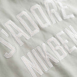 Close up of Embroidered text on a beige fabric background