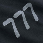 Close-up of a black fabric with white 777 logo