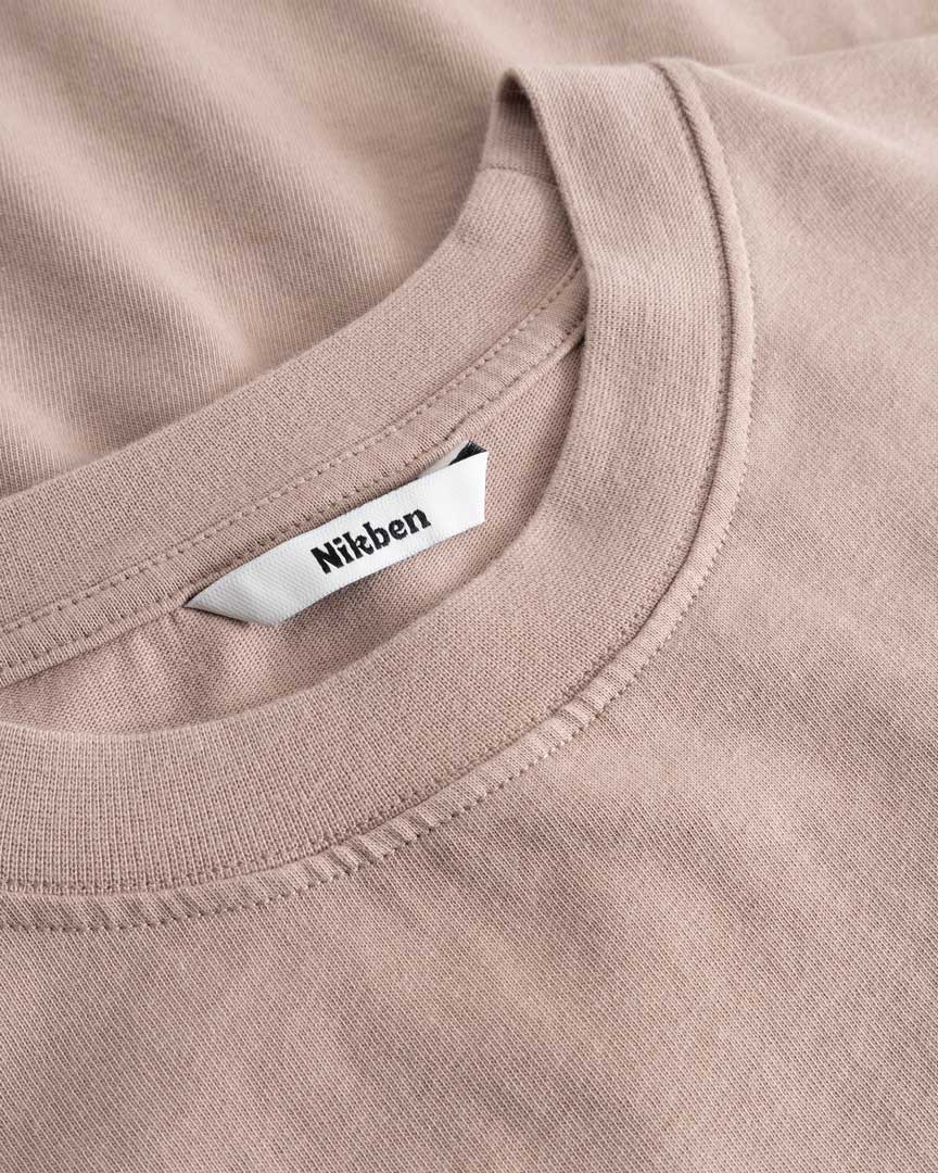 Closeup view of Nikben necklabel on brown T-shirt