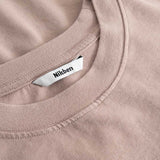 Closeup view of Nikben necklabel on brown T-shirt