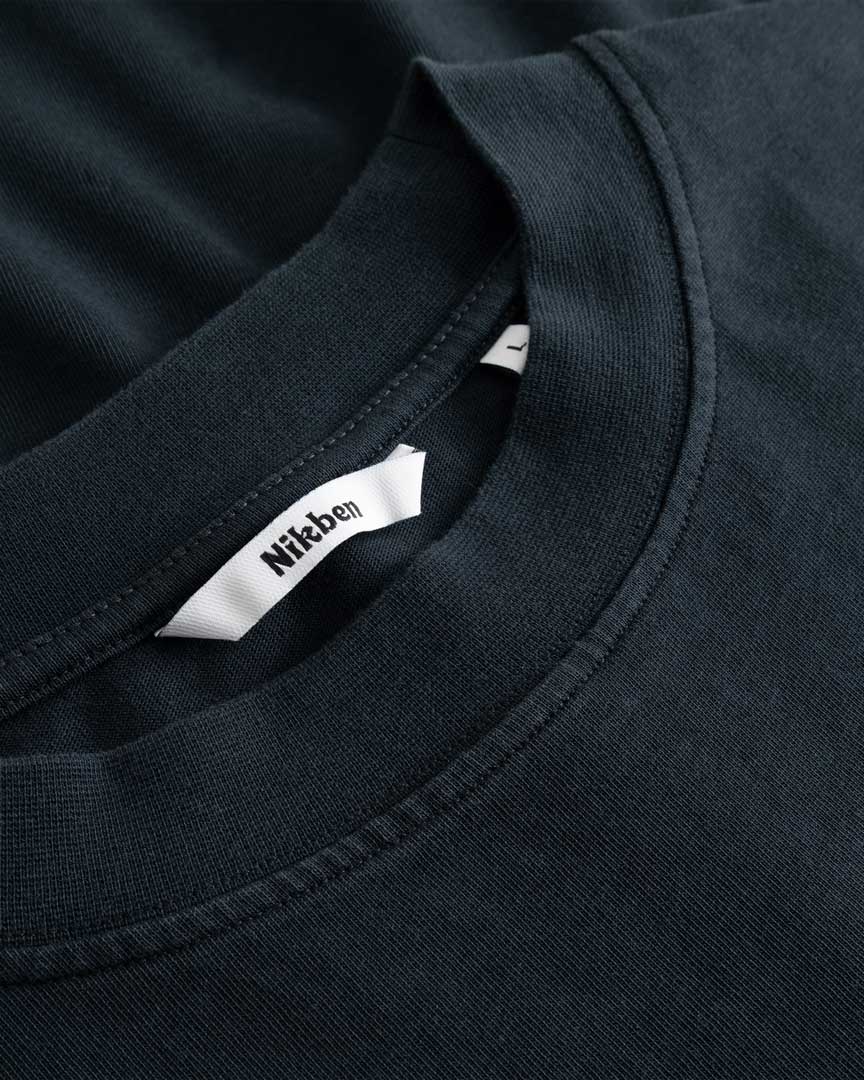 Closeup view of Nikben necklabel on black longsleeve T-shirt