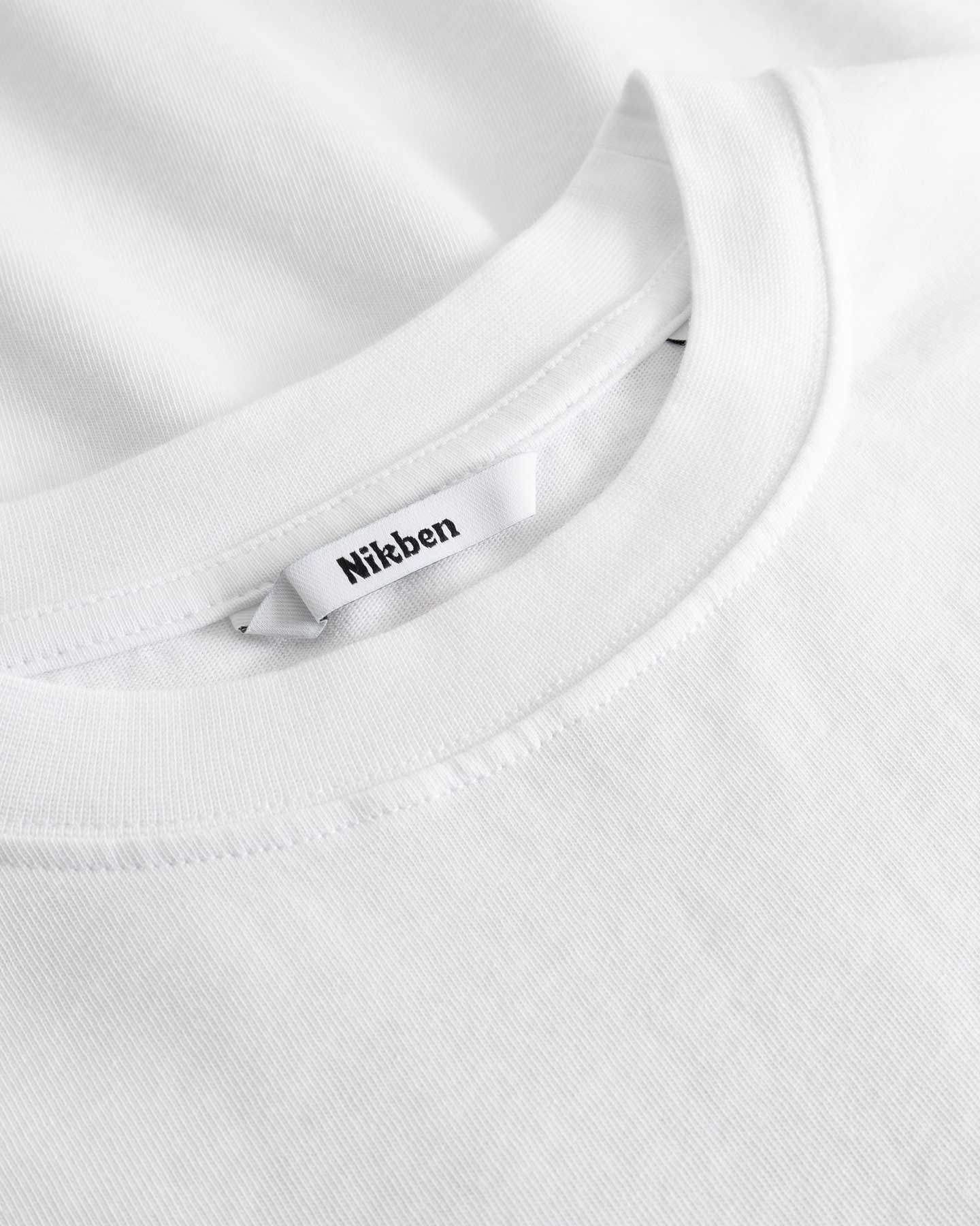 Closeup view of Nikben necklabel on white T-shirt