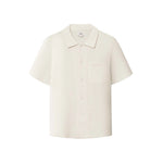 A short-sleeved off white shirt with a relaxed fit and a camp collar.