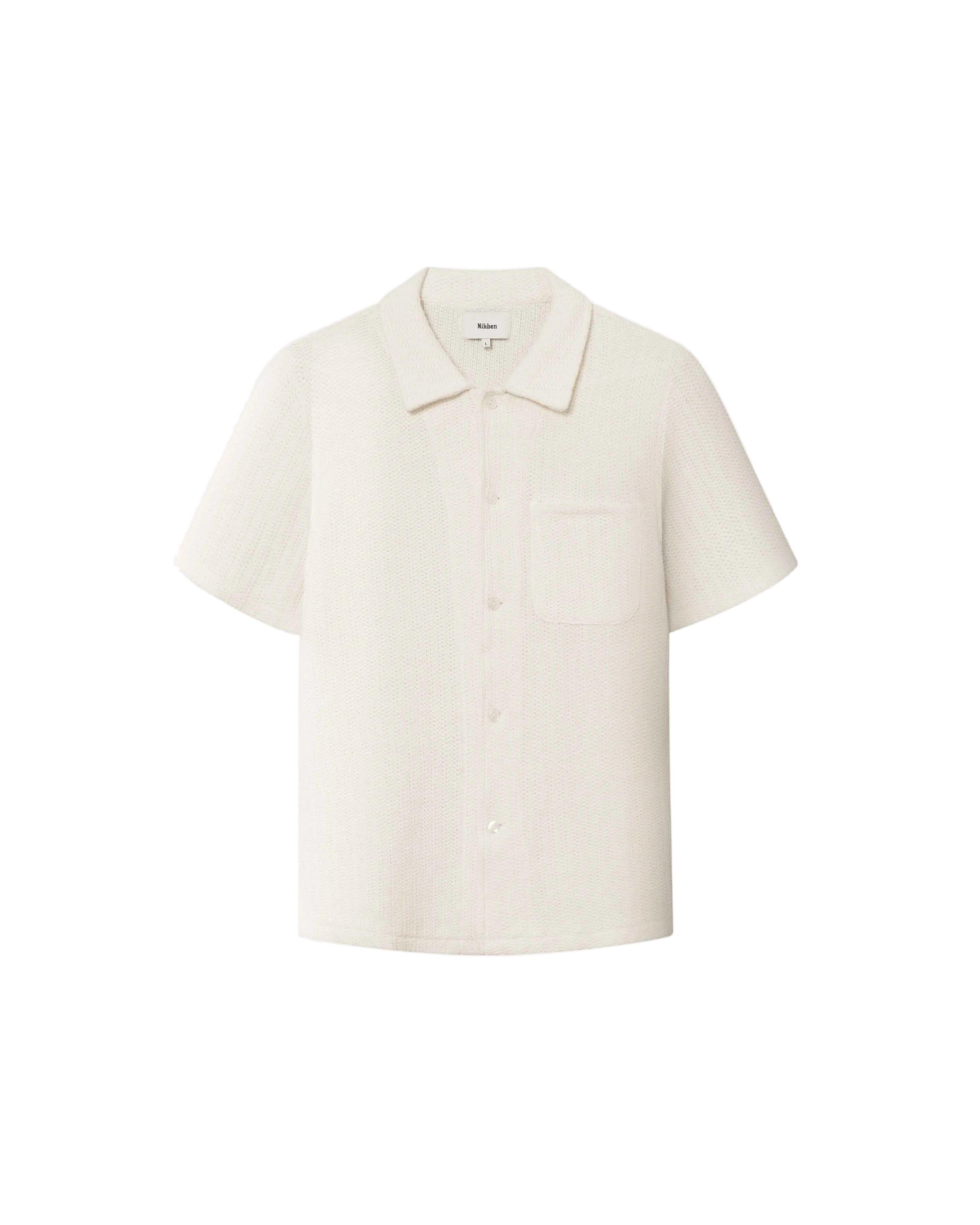 A short-sleeved off white shirt with a relaxed fit and a camp collar.