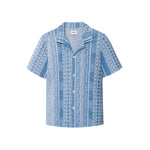 A short-sleeved blue shirt with geometric jacquard stitching, collar, and button-up front.
