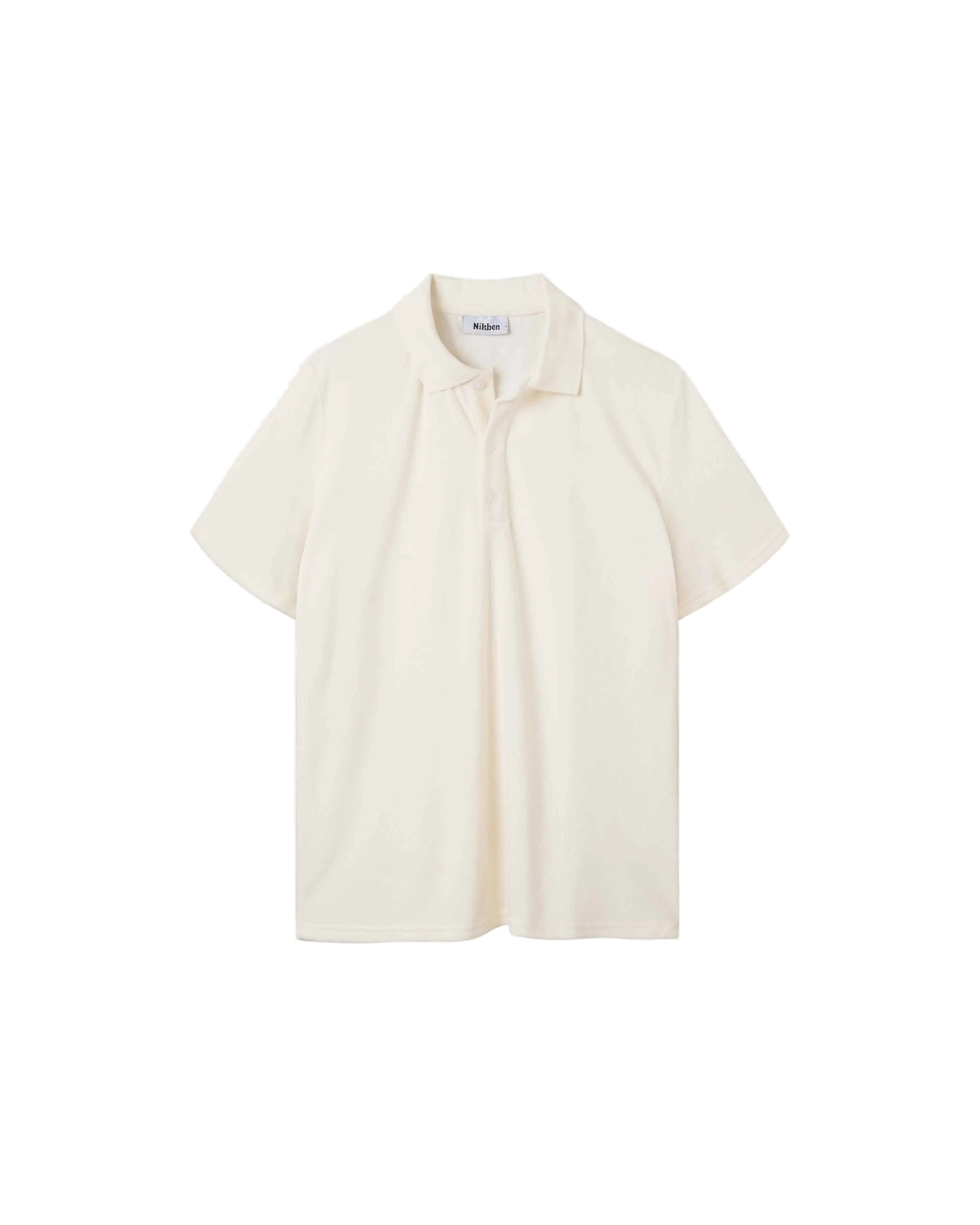 An off white, short-sleeved terry toweling shirt with pearl buttons and a collar.