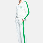 male model wearing white and green corduroy track suit pants with NB embroidery