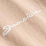 Close up of "jamaica" chest print on a sand colored t-shirt