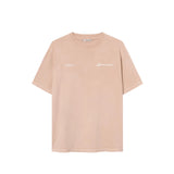 A sand colored t-shirt with "jamaica" text print on a sand colored t-shirt