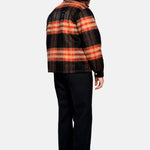 Back of male model wearing an orange red colored lumberjack jacket with pockets, full zipper and embroidered Nikben logo 