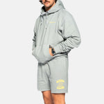 Male model wearing grey sweat shorts with drawstrings and yellow Nikben Sunshine Club print