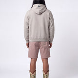 Back of male model wearing grey hoodie with blue flag print on the hood