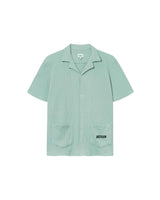 Mint green waffle-patterned short-sleeved shirt with two front pockets, featuring a stitched black Nikben logo on the left pocket and button closure.