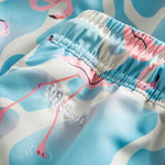 Logo on blue swim trunks with flamingo print