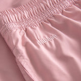 Logo on plain pink swim trunks