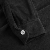 White button on black sleeve