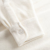 Sleeve on off white shirt with white button