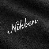 Close up of white logo script on black t-shirt.