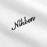 Close up of black logo script on white t-shirt.