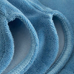 Close up on leg on white and sky blue low cut shorts in terry toweling fabric