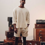 Male model wearing an off-white waffle-patterned sweatshirt with a stitched-on material label.